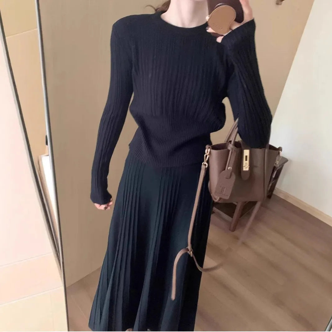 Dark grey knitted two-piece suit with 3D textured patterns, showing sweater and matching skirt
