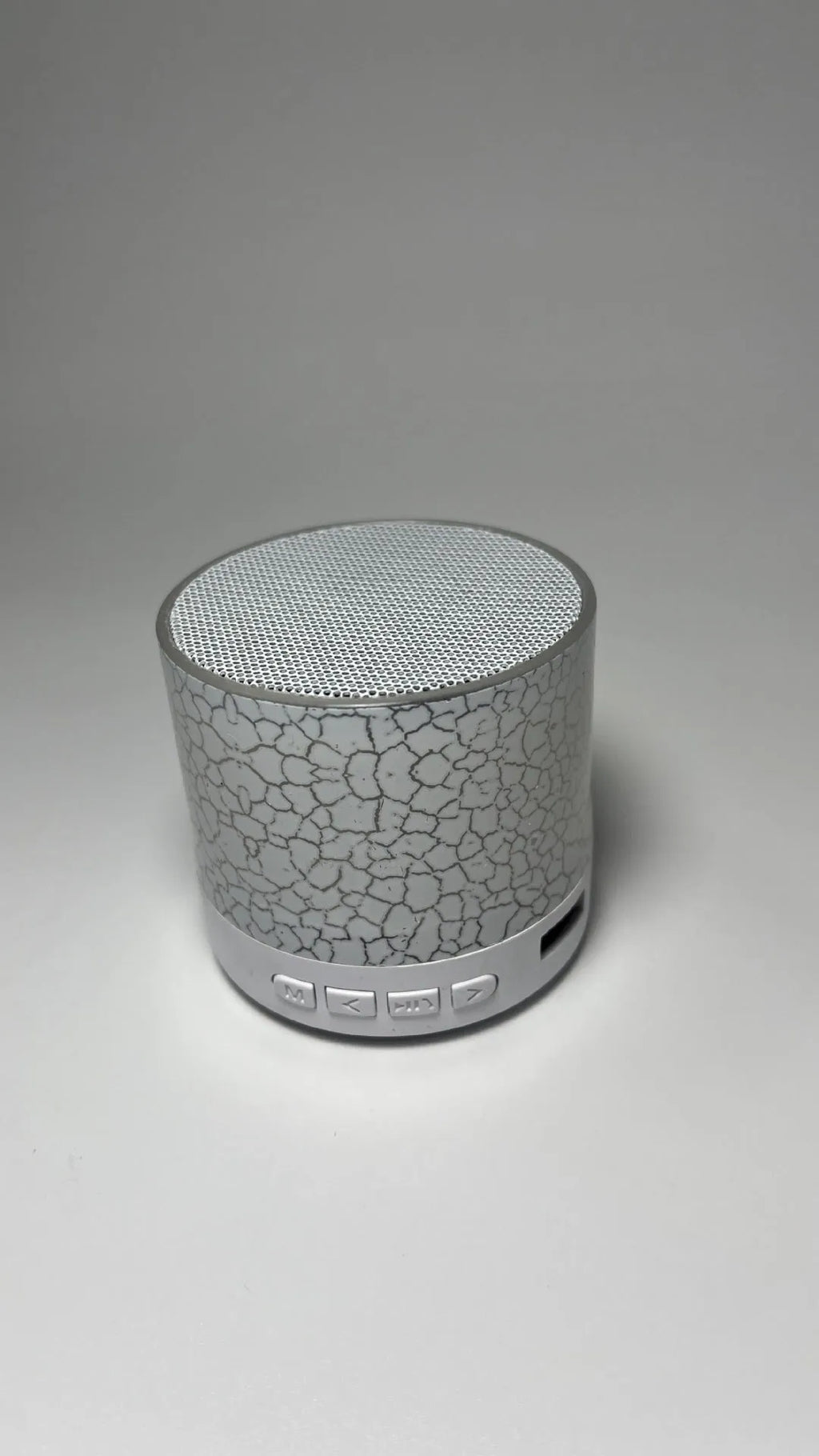 A9 Mini Cracked Bluetooth Speaker in blue with LED lights on a table