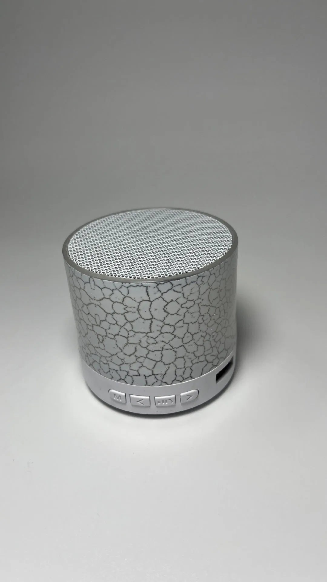 A9 Mini Cracked Bluetooth Speaker in blue with LED lights on a table