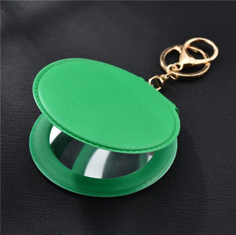 Compact round ladies leather makeup mirror with 8cm diameter glass surface and golden buckle