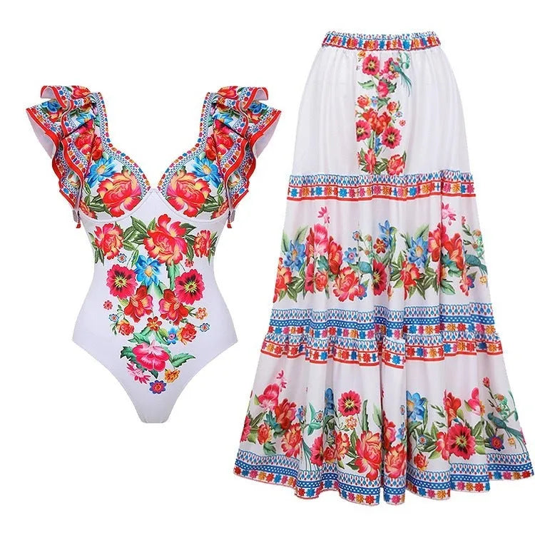 Adult woman modelling a printed one-piece swimsuit with a skirt detail in a blue colour.
