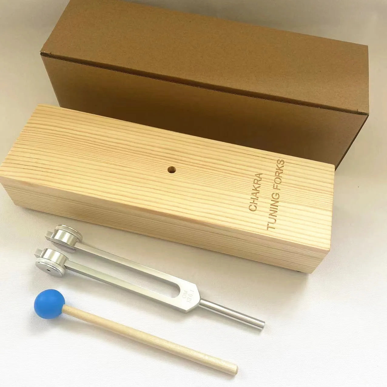 Aluminium alloy 432Hz tuning fork with acoustic speaker on kraft paper background