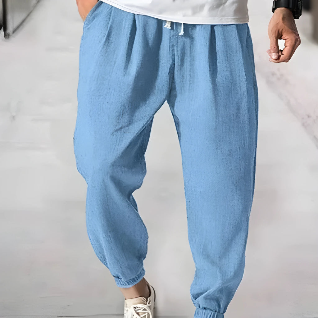 Men's cotton ankle banded trousers in light green colour showing loose fit and summer casual styling