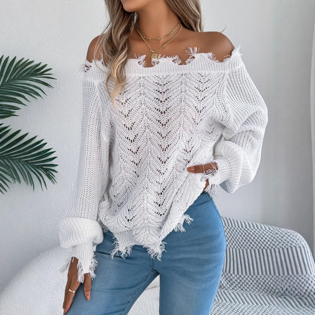 White hollow-out off-the-shoulder long sleeve pullover sweater laid flat.