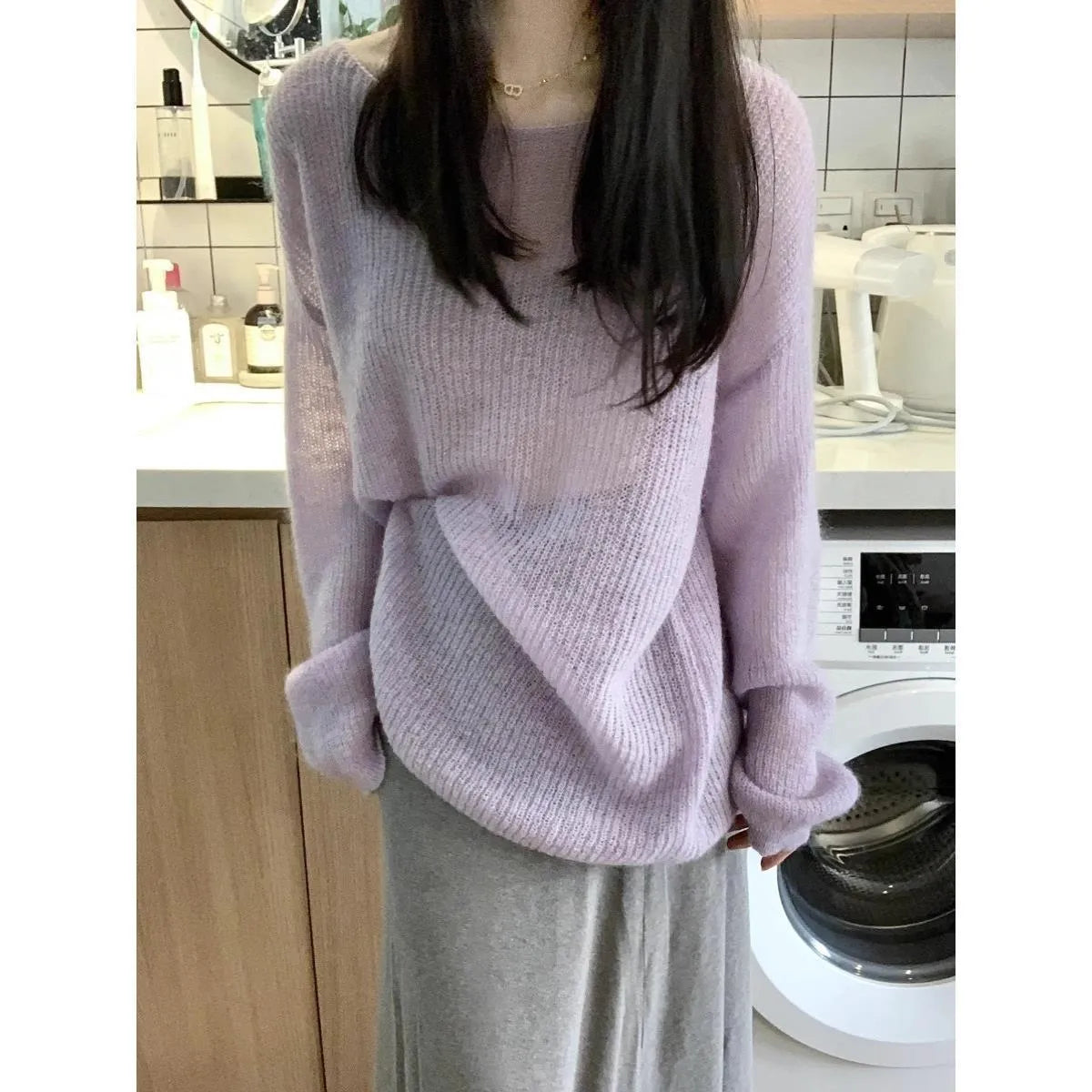 Purple women's sleeveless blouse with round neck and hollow out detailing on mannequin.