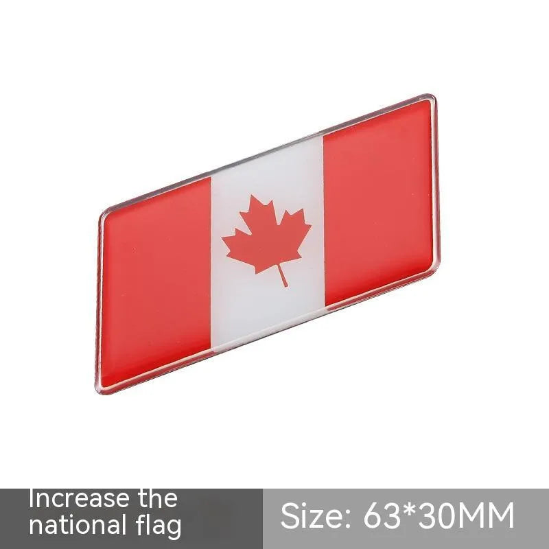 Aluminium parallelogram car sticker showing a national flag design, measuring 6.3 by 3 centimetres.