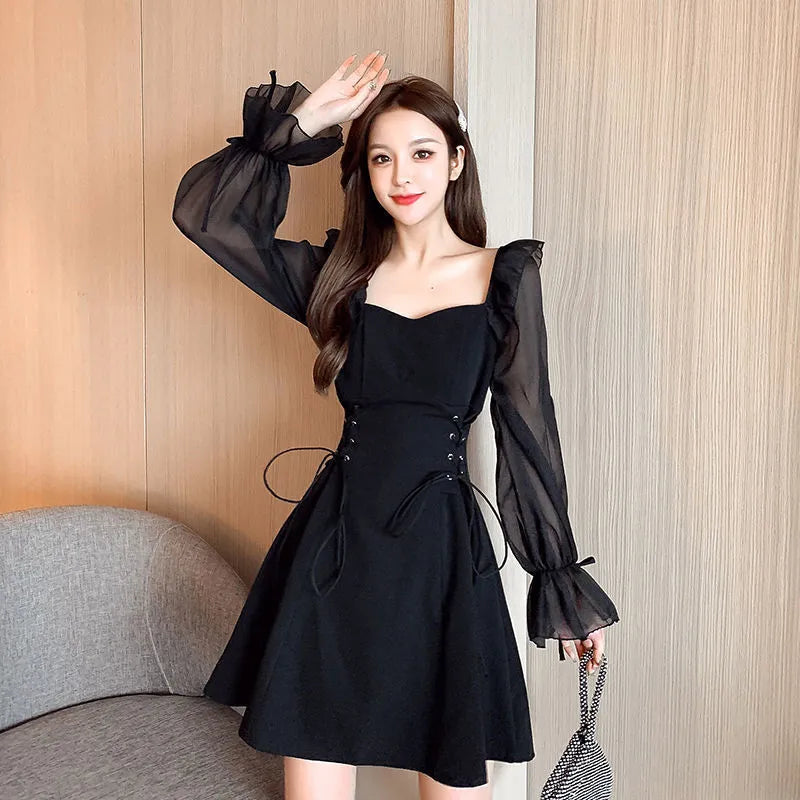 White long sleeve chiffon patchwork dress with a slim waist and floor-length skirt on a woman.