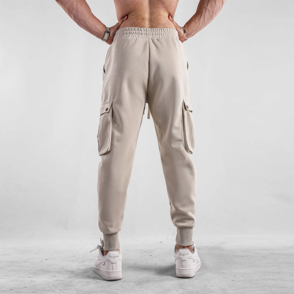 Men's cotton sports trousers with ankle ties and multiple pockets in apricot colour