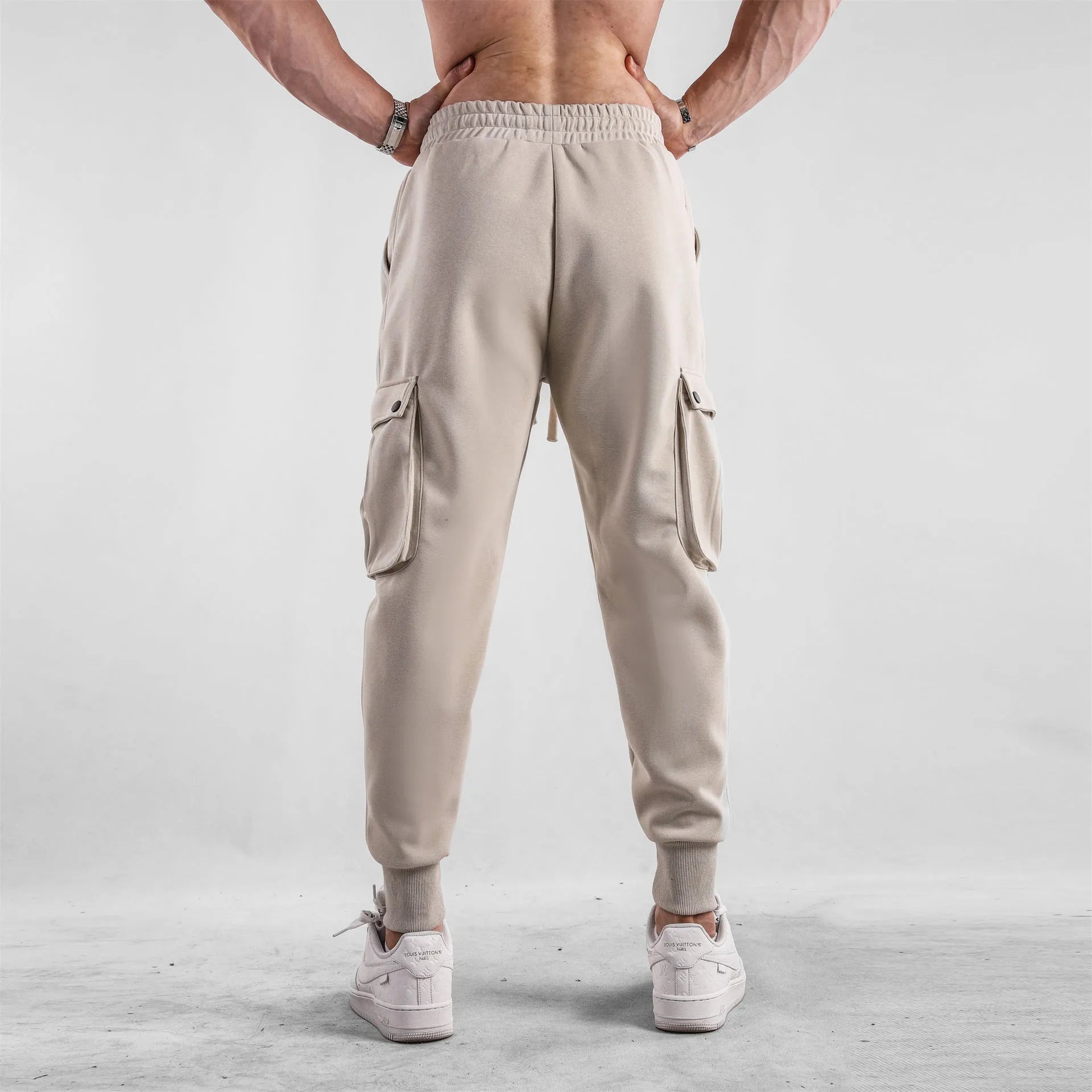 Men's cotton sports trousers with ankle ties and multiple pockets in apricot colour