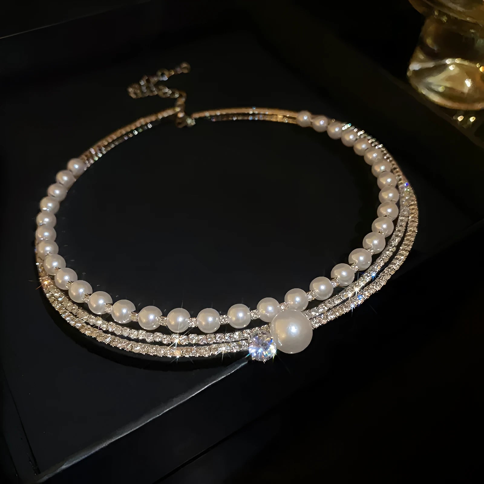 Round curved geometric clavicle chain necklace in electroplated silver on an alloy chain.