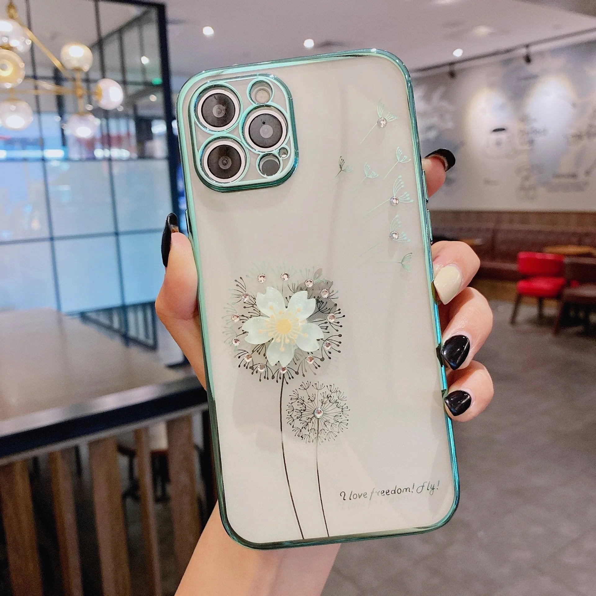 Green 3D floral patterned iPhone case with a silver rotating ring stand on the back.