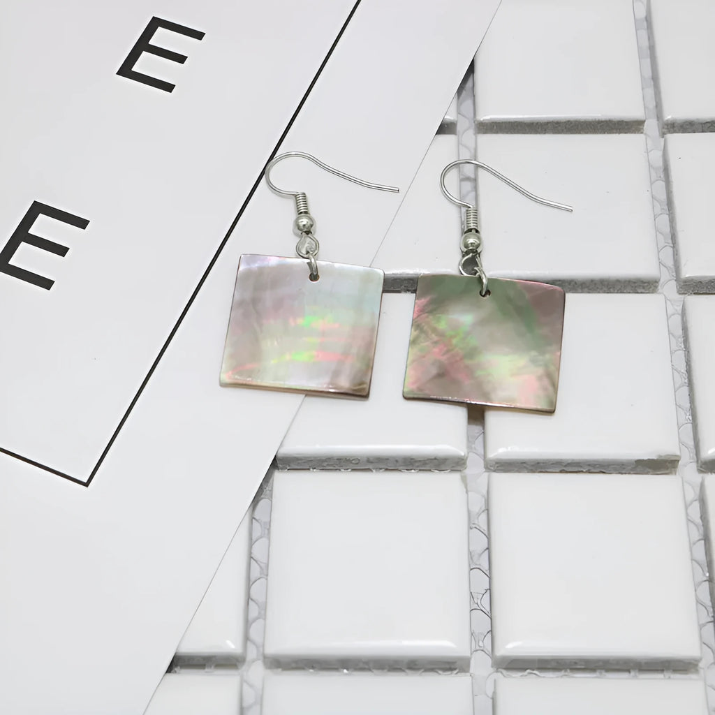 A pair of geometric-shaped earrings made from shell in a retro style, showing colour options.
