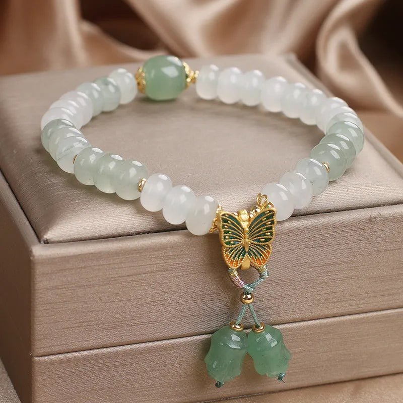 Green crystal Tian Shan Cui abacus bead bracelet with a retro butterfly tassel and pearl detailing.