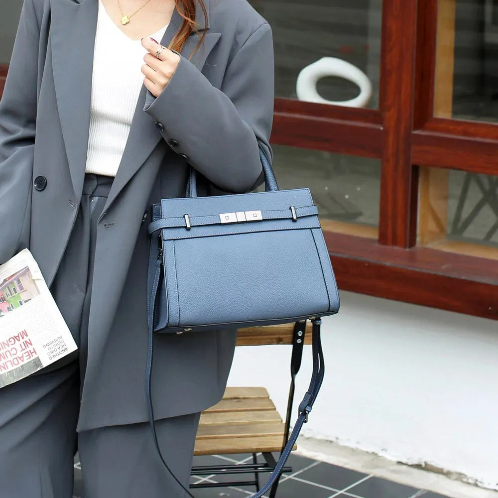 Genuine leather small square shoulder bag in almond green showing external pocket and stitching detail.