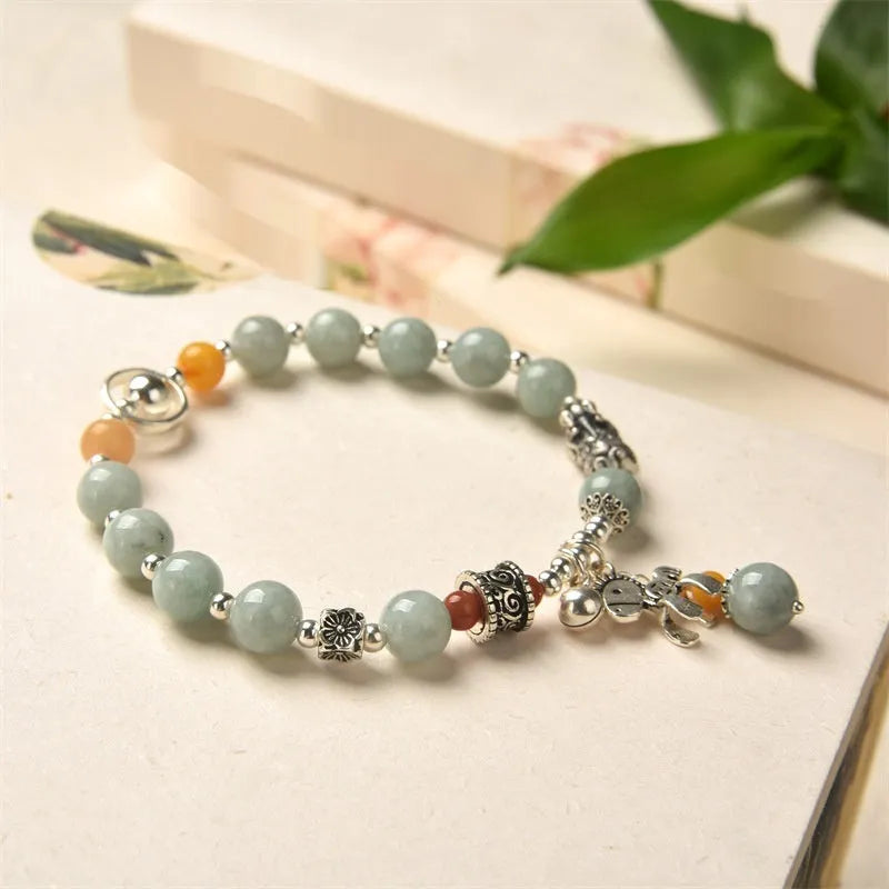 Natural emerald green vintage bracelet with jade stones on an alloy band, showing retro hand-crafted design.