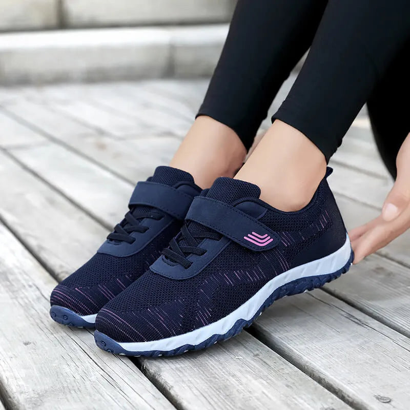 Women's grey purple low-top casual shoes with Velcro strap and wedge heel on a plain background.