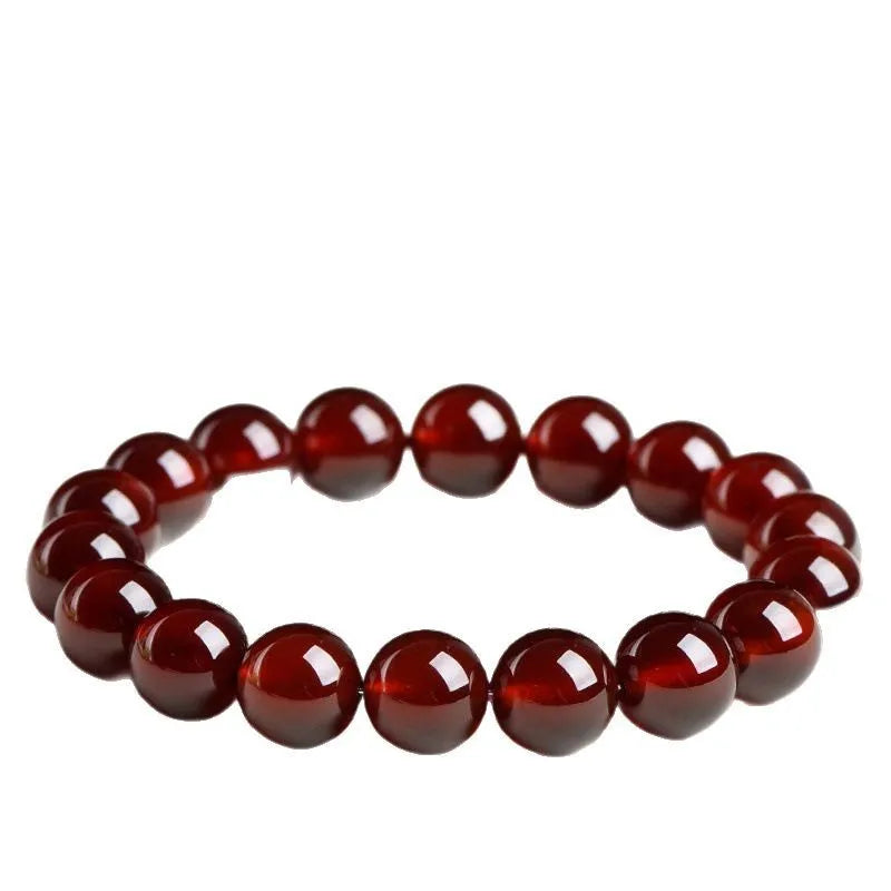 Natural orange red garnet ball crystal bracelet with traditional ruyi design elements on wrist