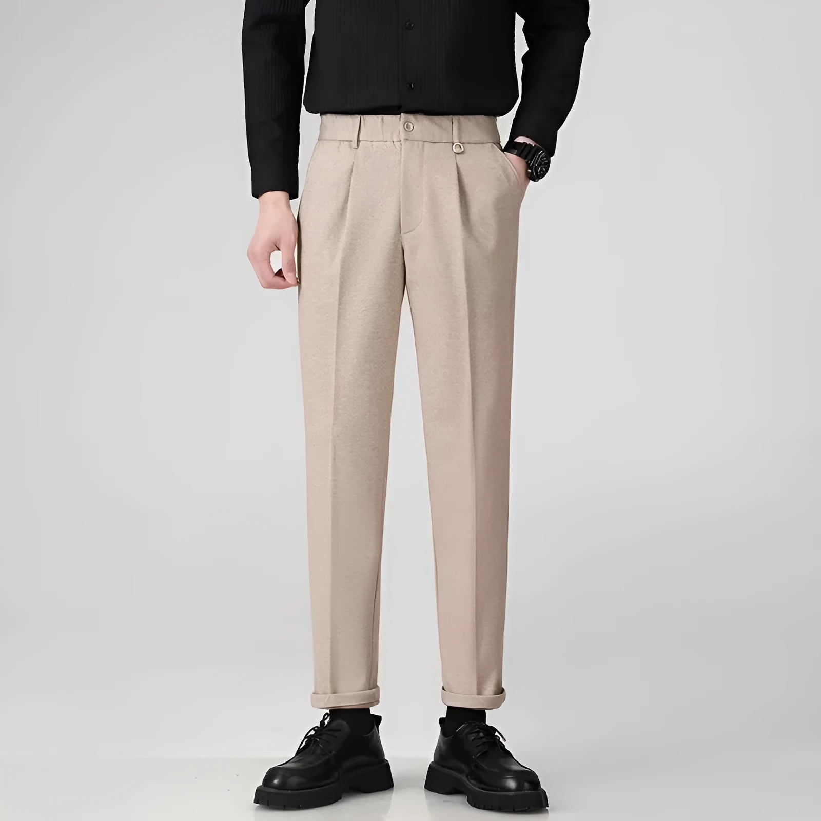 Man wearing grey straight leg polyester trousers for a smart casual look.