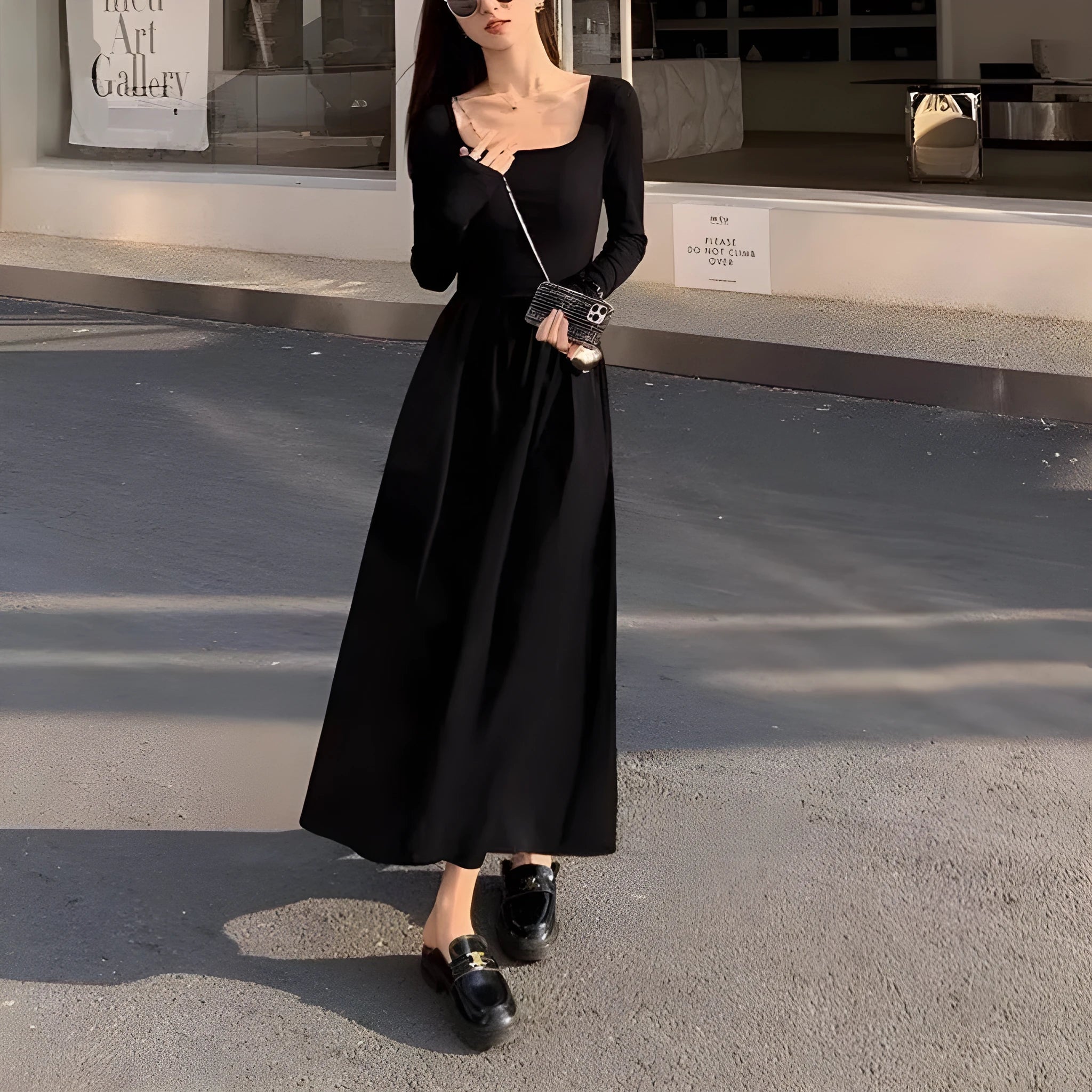 Women's black knitted dress with square collar, long sleeves, elastic waist, and A-line floor-length skirt