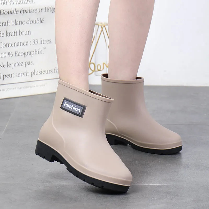 Women's mid-calf PVC rain boots in black with low heel design