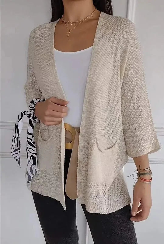 Women's army green waffle knit cardigan coat with nine-quarter sleeves and pockets.