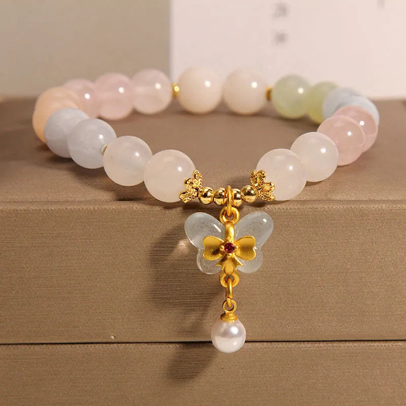 Women's colourful Morgan stone butterfly pendant crystal bracelet on wrist.