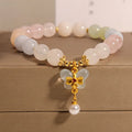 Women's colourful Morgan stone butterfly pendant crystal bracelet on wrist.
