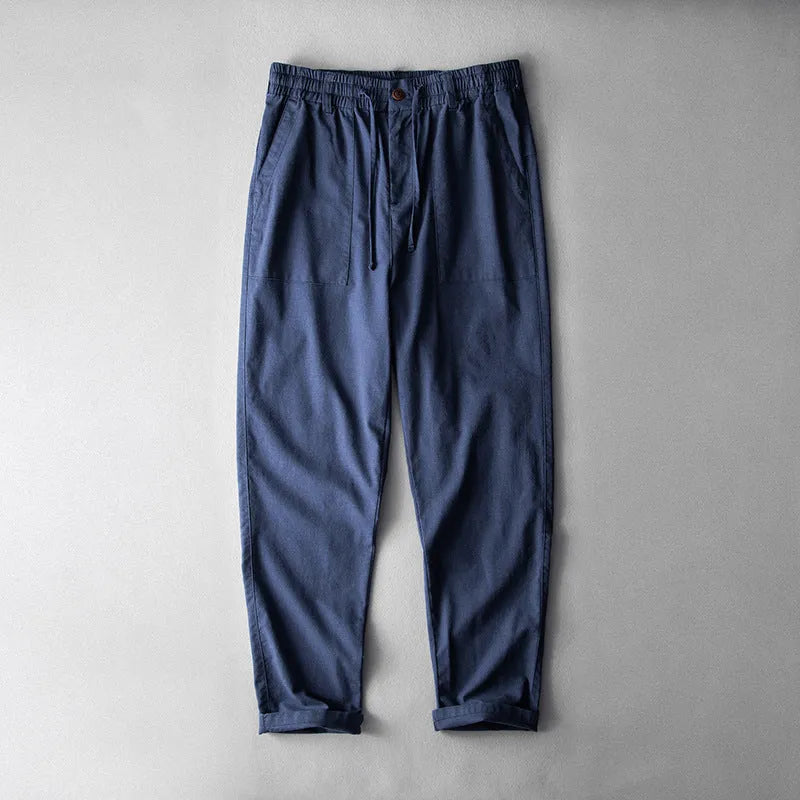 Men's solid colour linen casual trousers in navy blue, shown from the front.