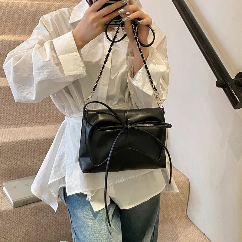 Women's underarm crossbody bag in horizontal square shape with sandwich pocket design and crossbody strap