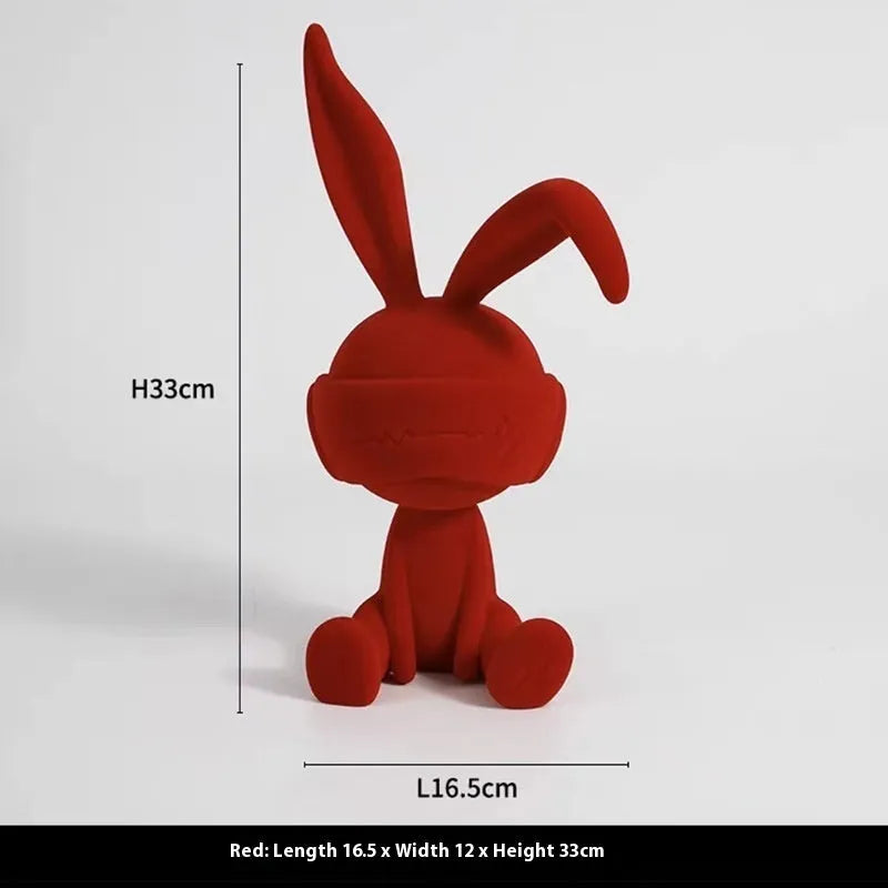 Green suede blindfold rabbit resin table ornament on wooden surface