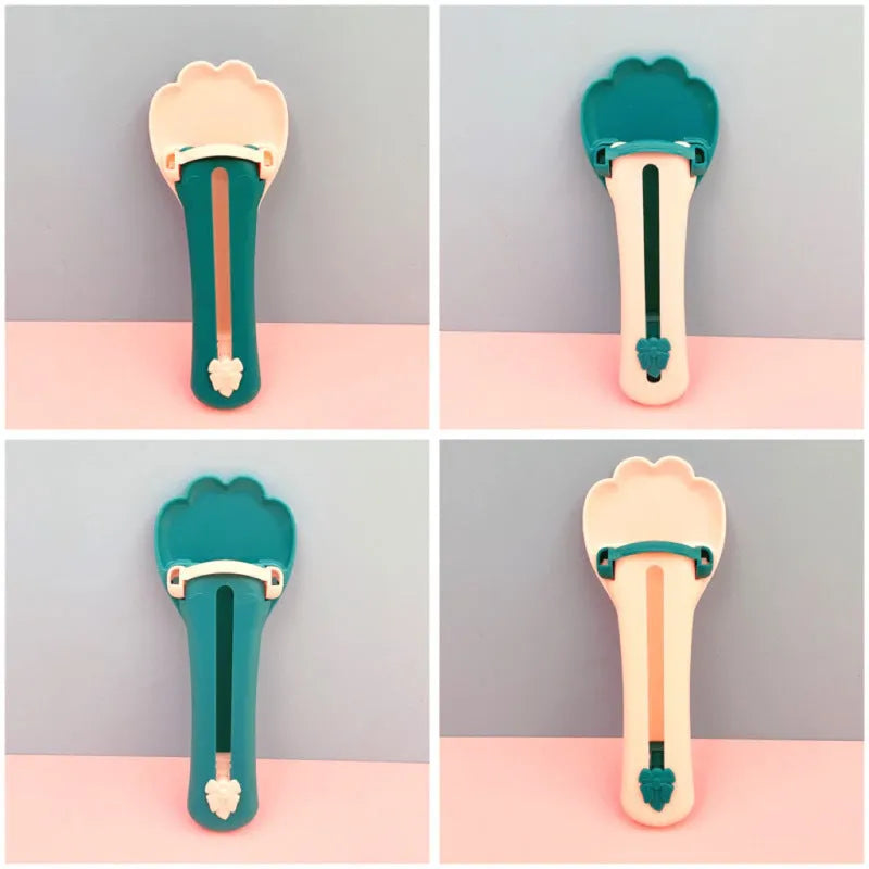 Green and pink pet feed spoon and snack squeezer tool for cat and dog food.