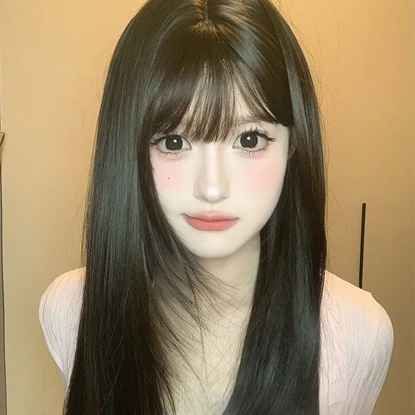 Dark brown long straight synthetic wig with bangs on wig head, showing full-head coverage
