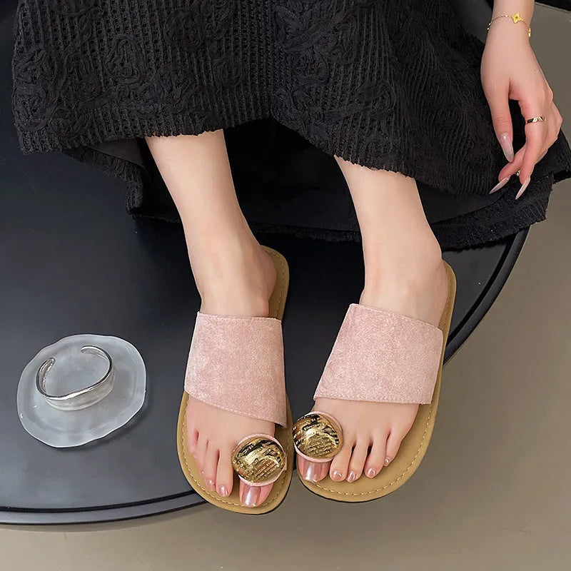Women's flat bottomed French toe flip flops in solid colours on a light background