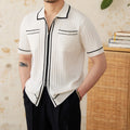 Slim black and white elastic knit polo shirt with lapel collar and short sleeves on hanger