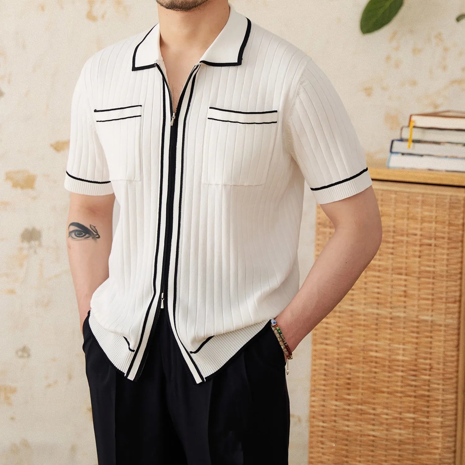 Slim black and white elastic knit polo shirt with lapel collar and short sleeves on hanger