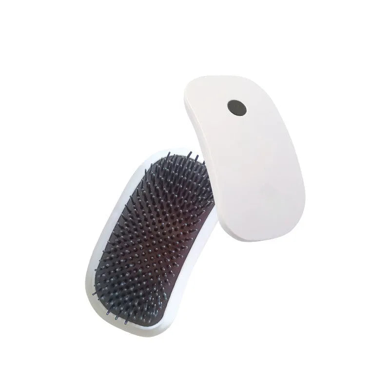 Pink handheld electric pet massage brush with soft TPE teeth on a white background.