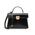 Women's black leather shoulder bag with vachette clasp showing internal compartments and adjustable strap