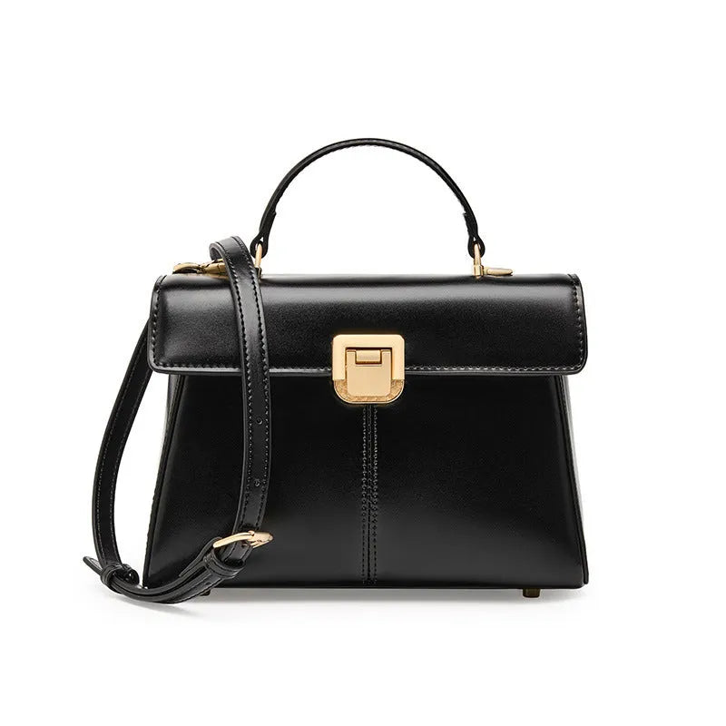 Women's black leather shoulder bag with vachette clasp showing internal compartments and adjustable strap