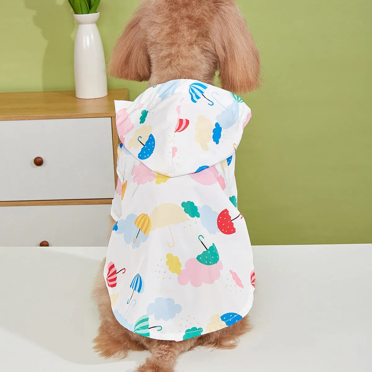 Colourful cartoon umbrella pattern pet raincoat for dogs or cats, available in sizes XS to XL.