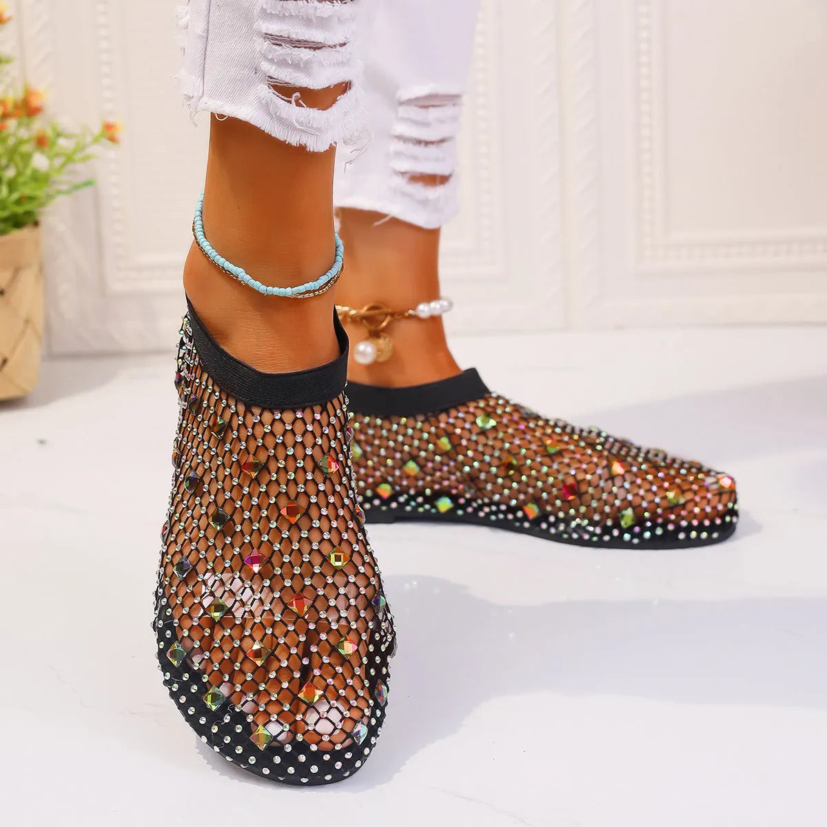 Women's colourful rhinestone flat sandals with mesh upper and rubber sole.