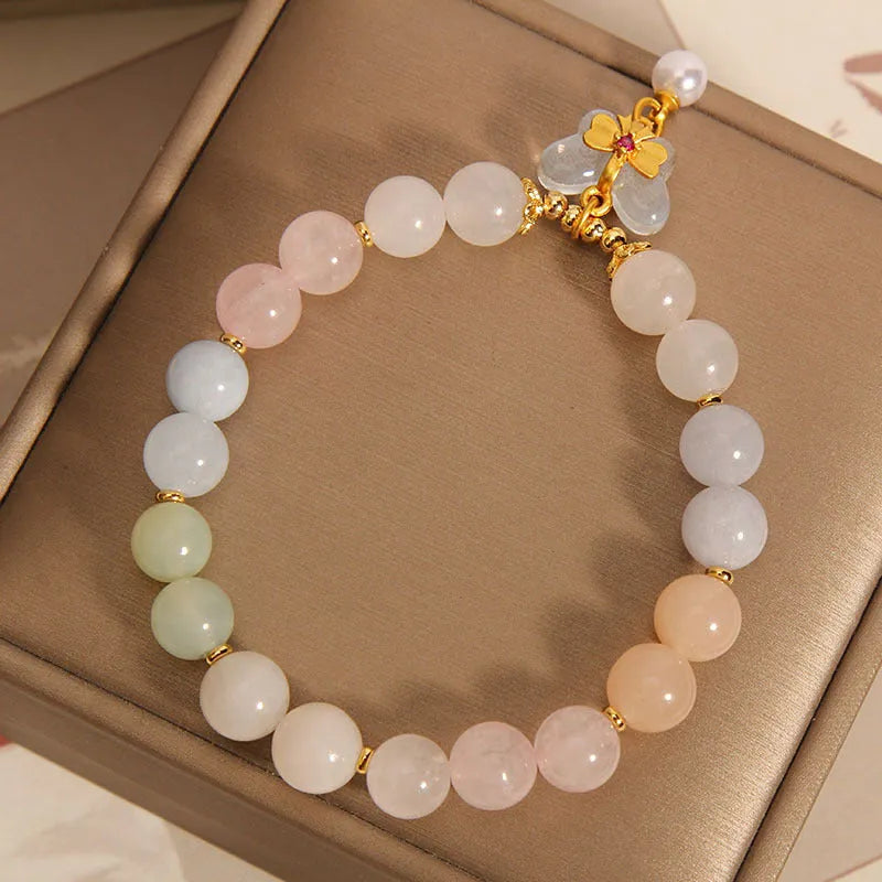 Women's colourful Morgan stone butterfly pendant crystal bracelet on wrist.