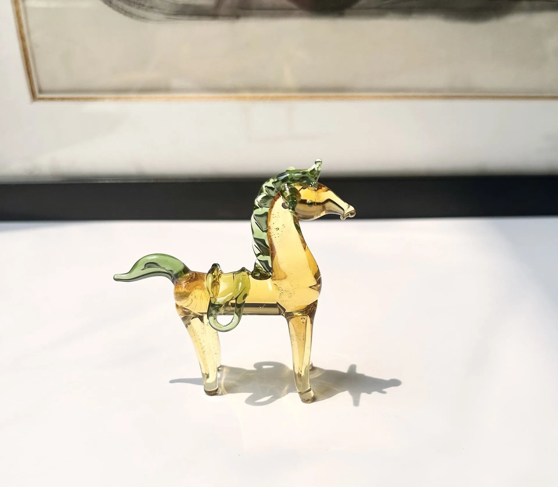 Glazed brown horse figurine on wooden desk as office decoration