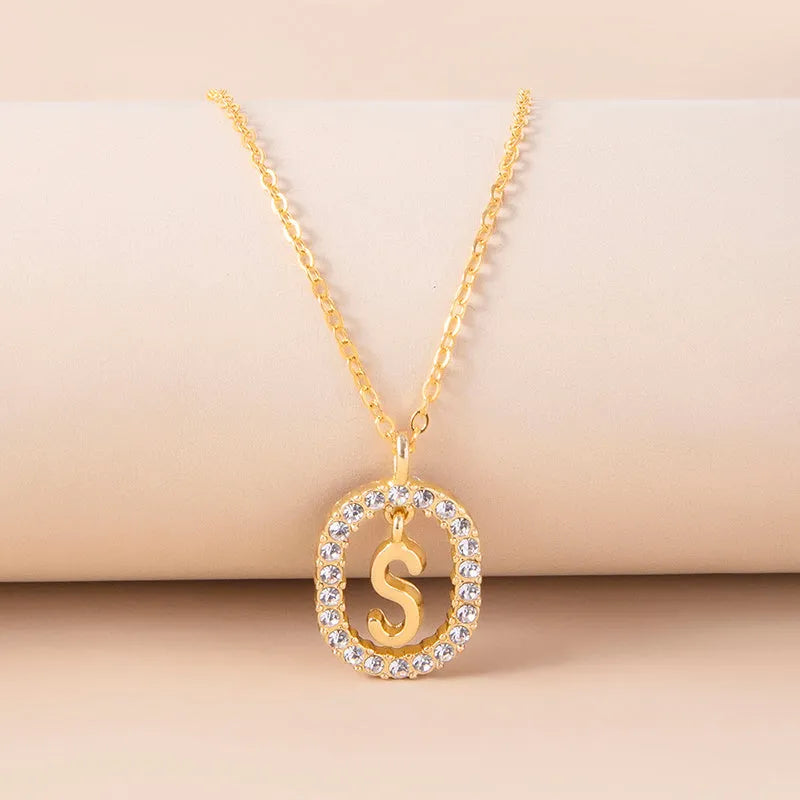 Gold crystal letter initial oval pendant necklace on woman, rhinestone letter in zinc alloy frame with adjustable chain