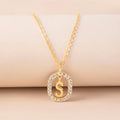 Gold crystal letter initial oval pendant necklace on woman, rhinestone letter in zinc alloy frame with adjustable chain