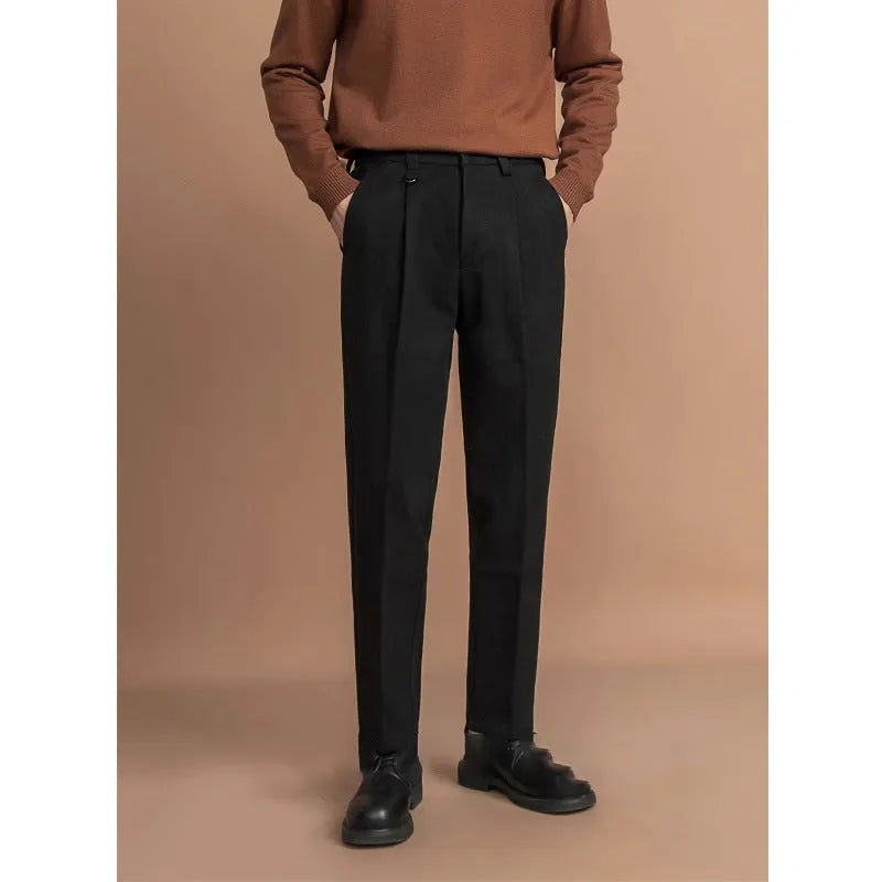 Man wearing grey straight leg polyester trousers for a smart casual look.
