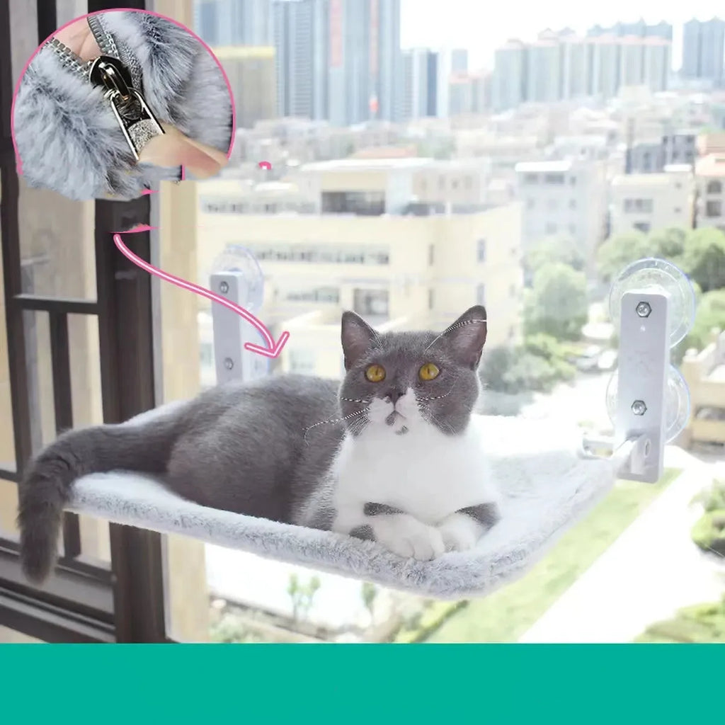 Cat resting on a suction cup window hammock made of plush fabric and steel in beige colour