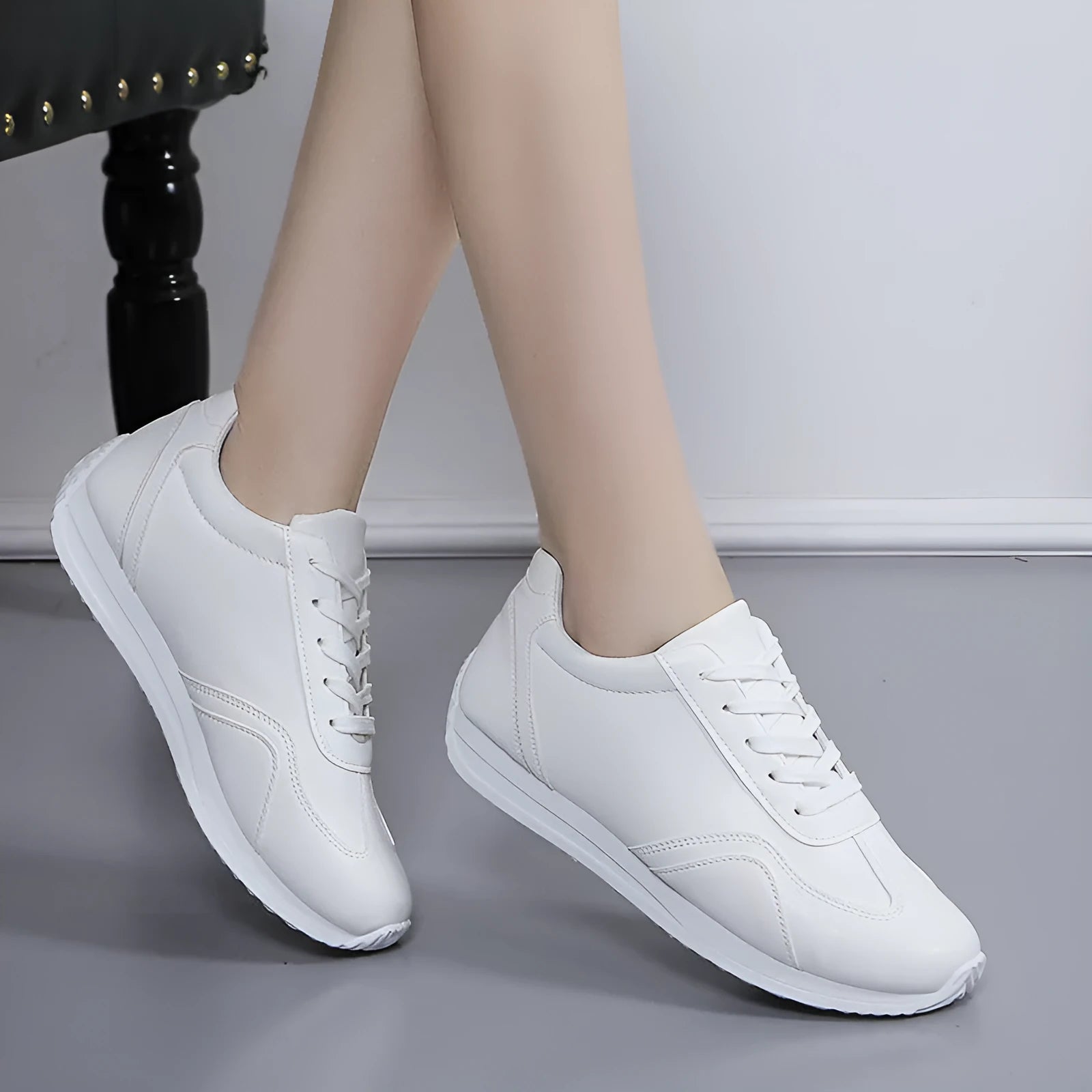 Women's white platform casual sneakers with thick sole, lace-up closure, and rubber outsole on a neutral background