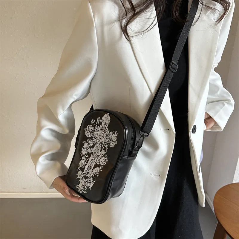 Black mini crossbody phone bag with Halloween graffiti print showing pumpkins, ghosts and bats