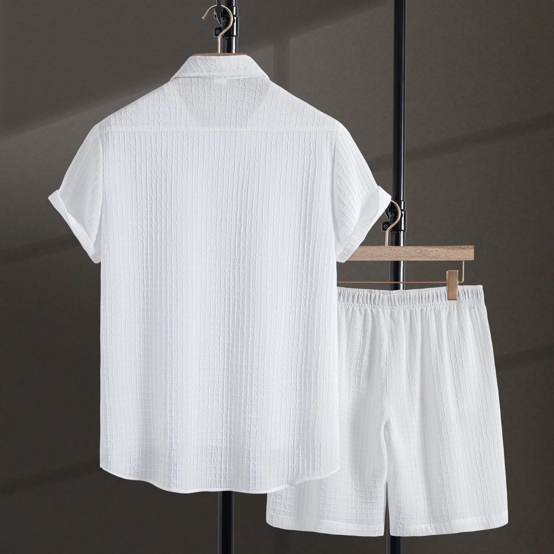 Men's white jacquard cotton blend short sleeve shirt and matching shorts laid flat.