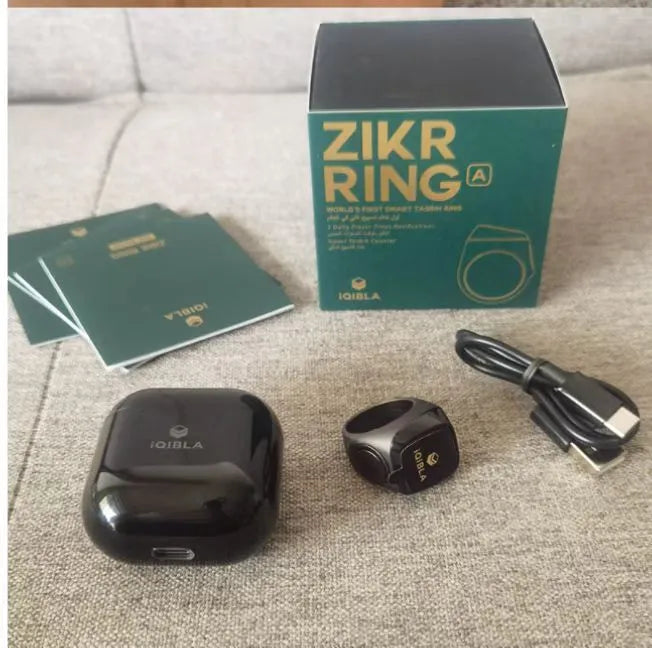 Zikr1 metal smart ring with OLED screen on a finger, showing a Tasbih count.